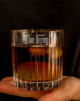 Glass of whiskey held by a hand with 'The Grey' by Yoonek Gifts