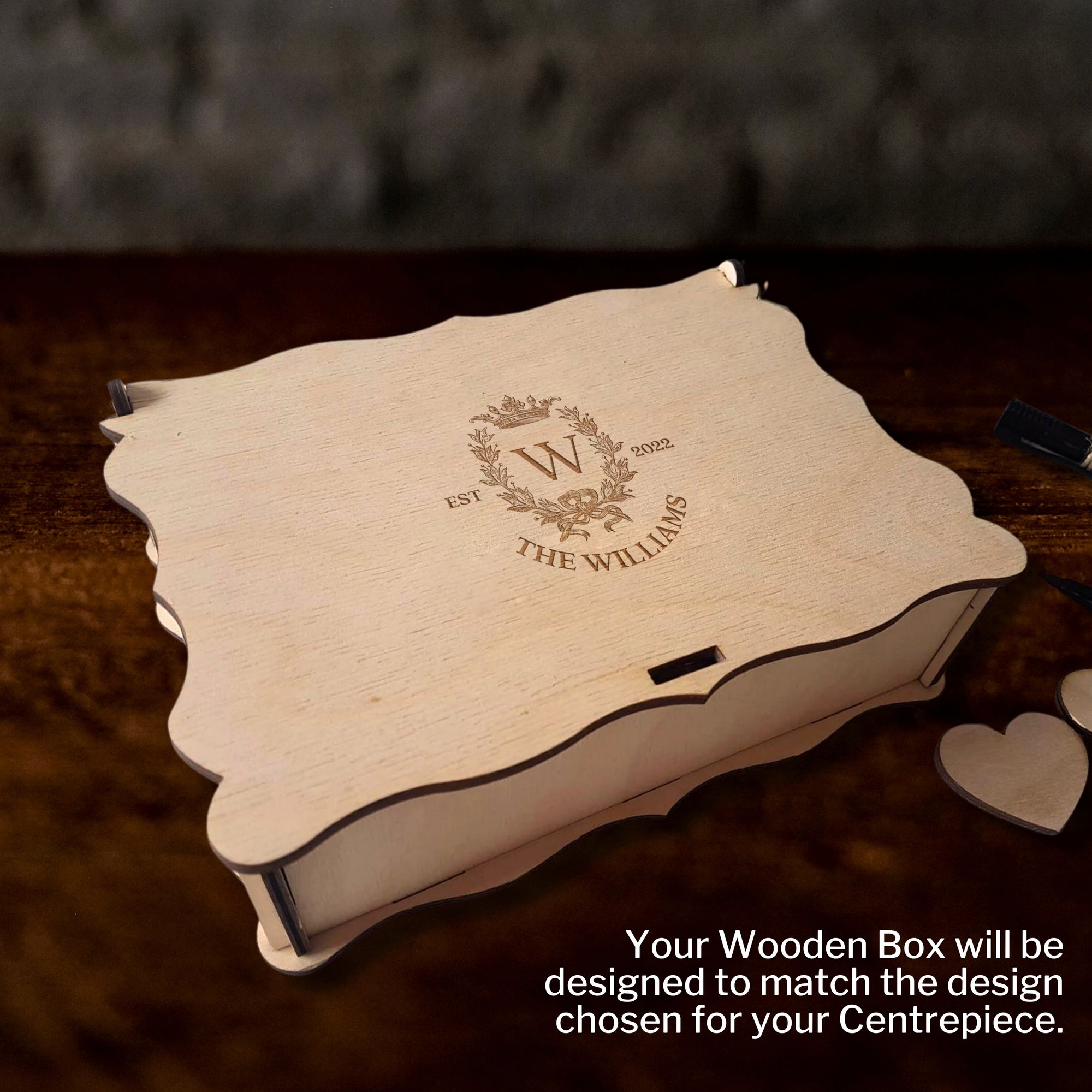 Wooden box with engraved design on a dark surface