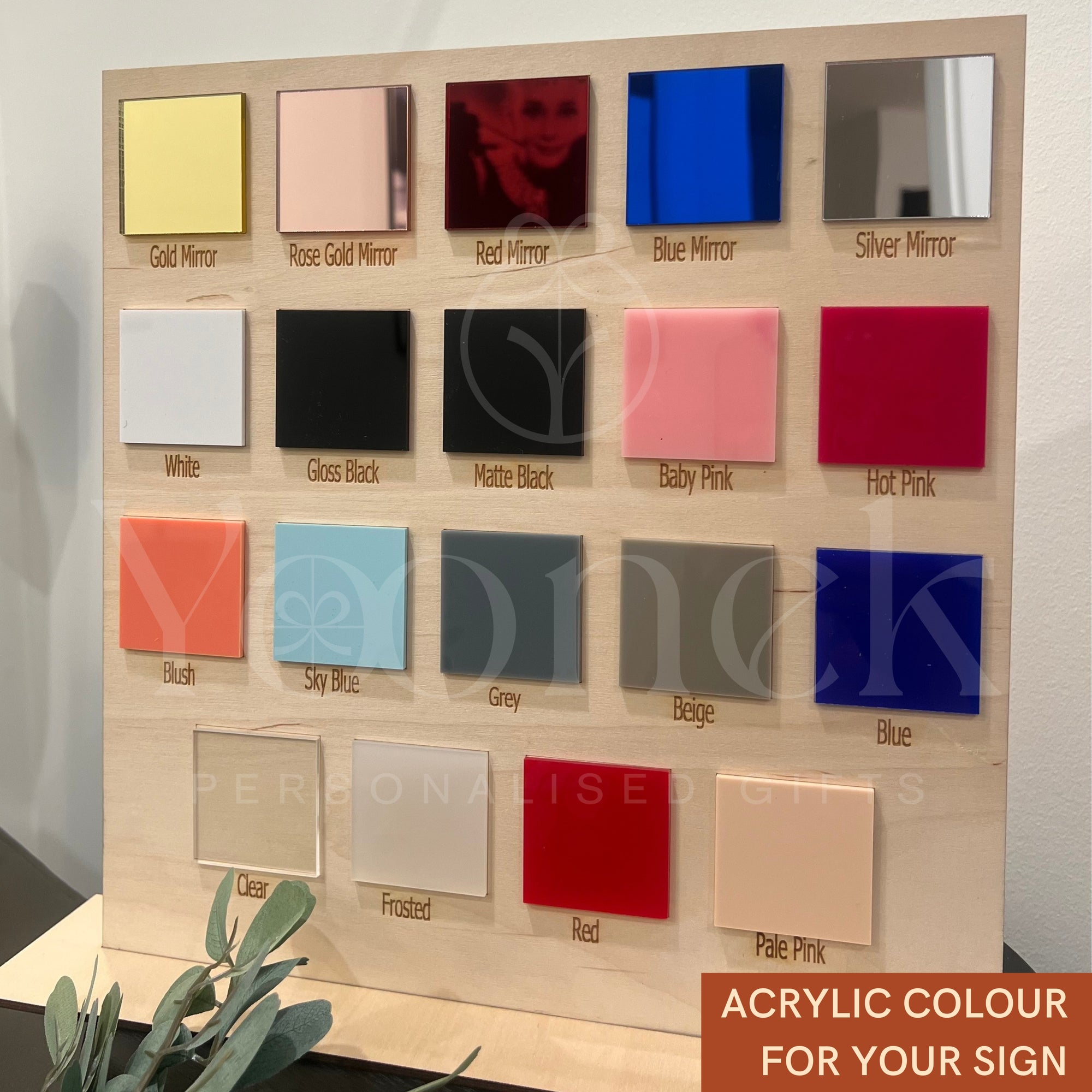 Acrylic color swatch board with various colors on a wooden frame