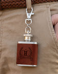 Close-up of laser engraved name on personalised leatherette mini hip flask keyring