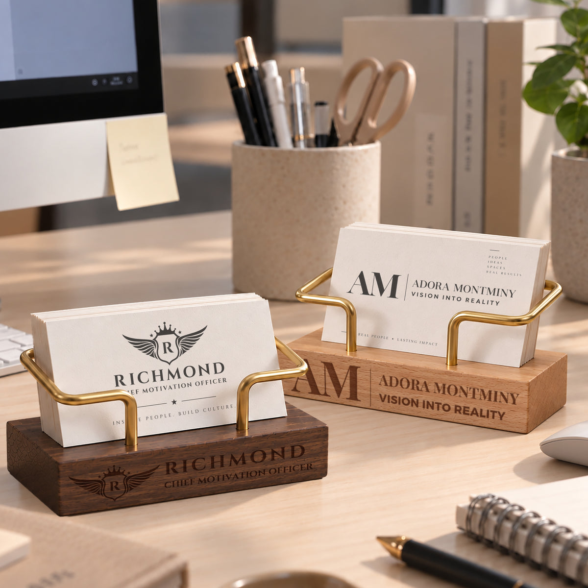 Engraved wooden business card holders with custom logos on a desk