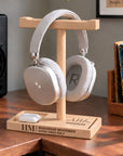 Personalised beech headphone stand holding headphones with an engraved name and storage tray