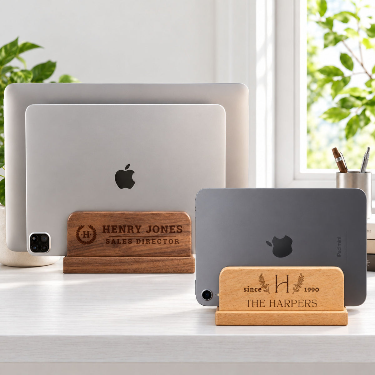 Personalised wooden laptop and tablet stands in beech and walnut holding a laptop and tablet